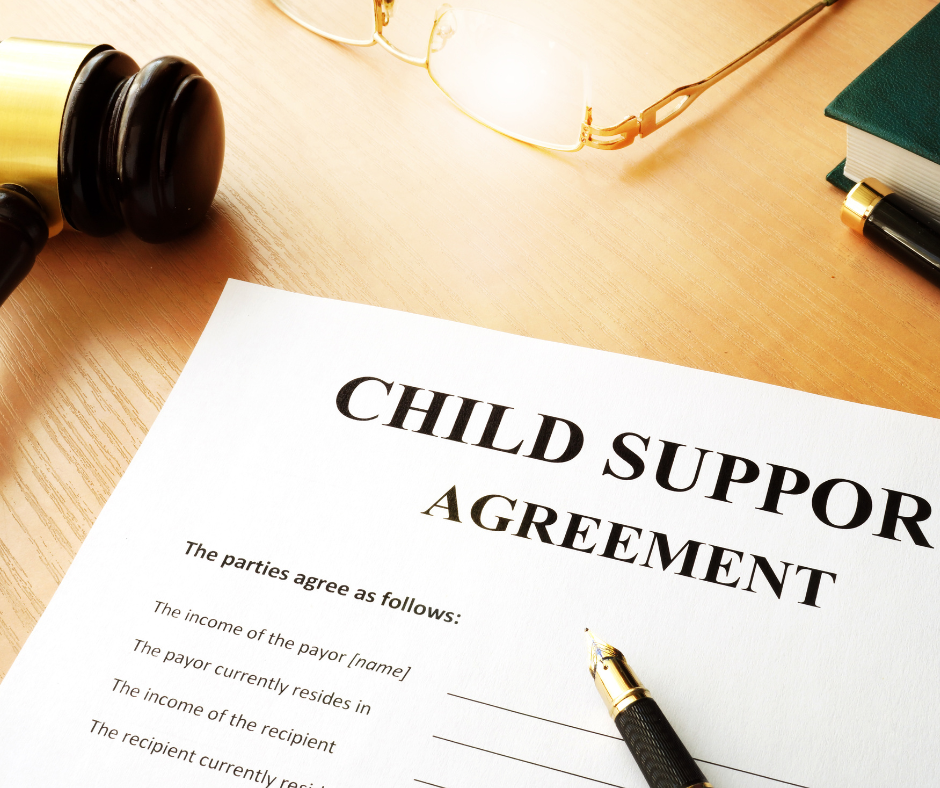 Child support agreement document with gavel and pen on a wooden desk